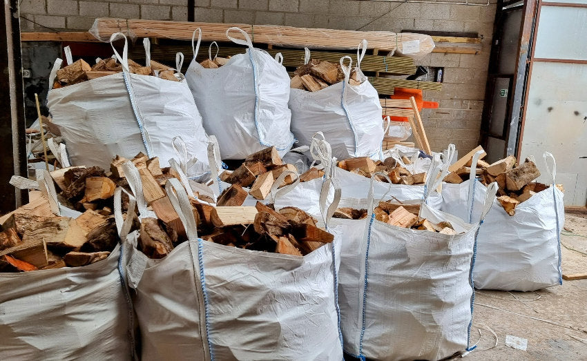Bags of firewood stacked in a warehouse setting