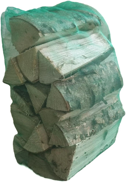 Stack of chopped wood with a green mesh bag on a white background